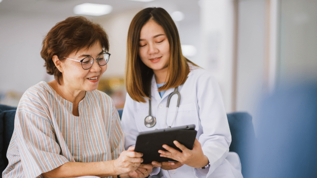 Doctor and patient reviewing medical files during consultation, explaining how Anisa HealthPro’s service works.